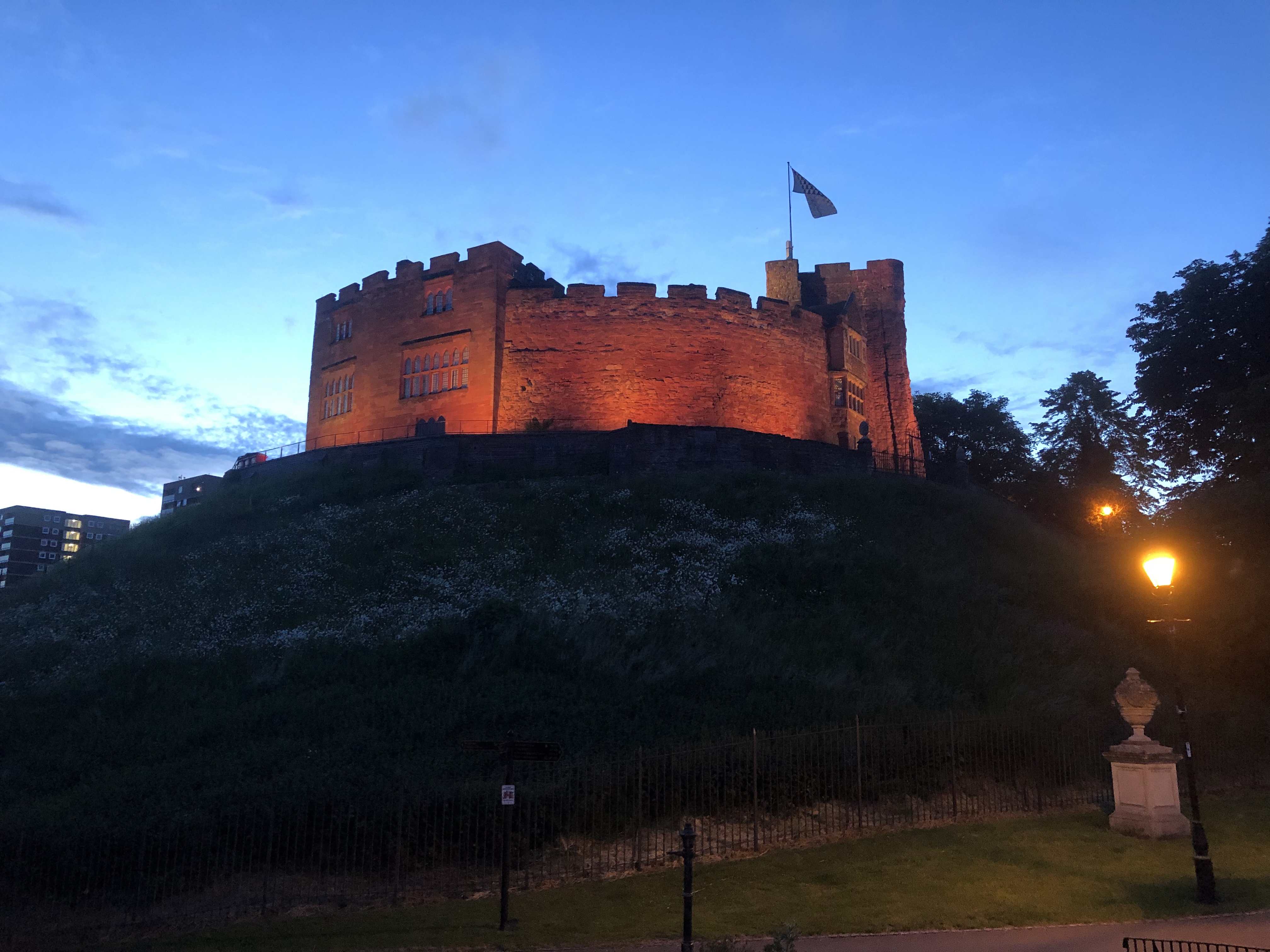 Tamworth Castle lit up yellow in the evening
