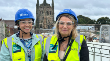 Two people stood in front of a church
