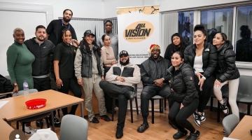 Group photo of a team with roll up banner